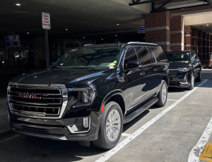Premium Luxury SUV GMC YUKON XL and Premium mid-size luxury SUV Cadillac XT6 Sedan at Savannah Hilton Head International Airport picking up flight crew to go to downtown Savannah